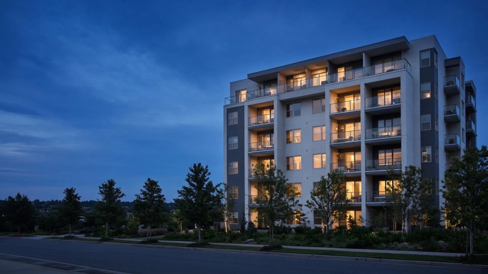 Six-story multifamily residential building at dusk, published on the Evo Drywall website.
